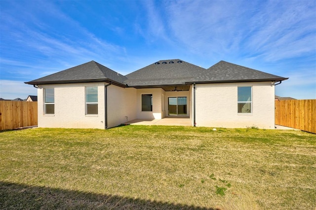 back of house with a patio area and a yard