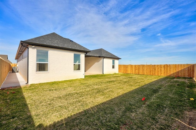 rear view of property with a lawn