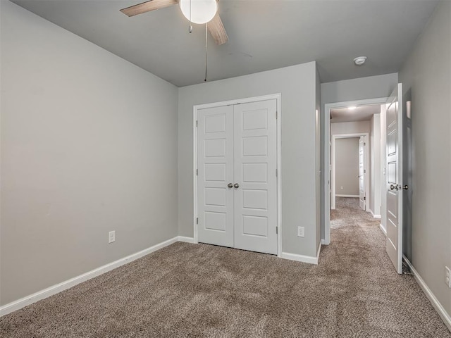 unfurnished bedroom featuring ceiling fan, carpet floors, and a closet