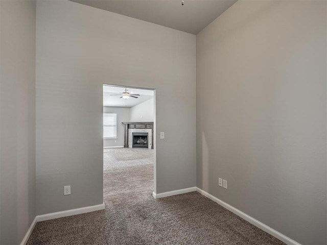 empty room featuring ceiling fan and carpet floors