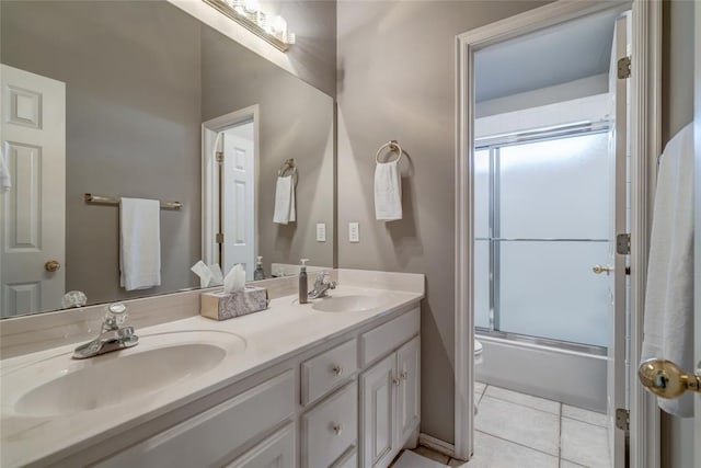 full bathroom with tile patterned floors, vanity, toilet, and combined bath / shower with glass door