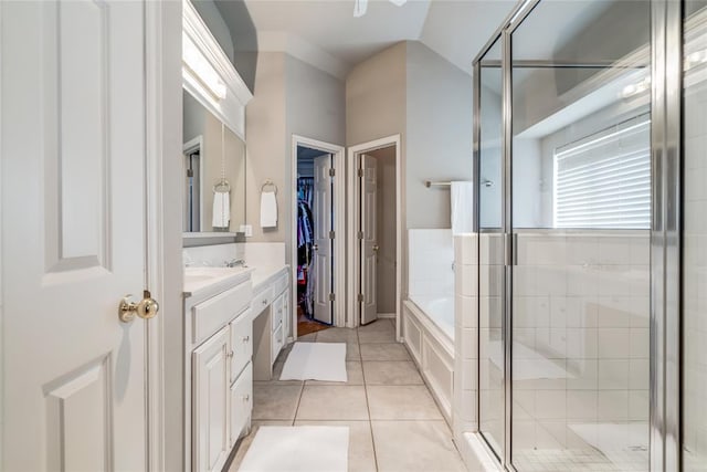 bathroom with tile patterned floors, vanity, lofted ceiling, and shower with separate bathtub