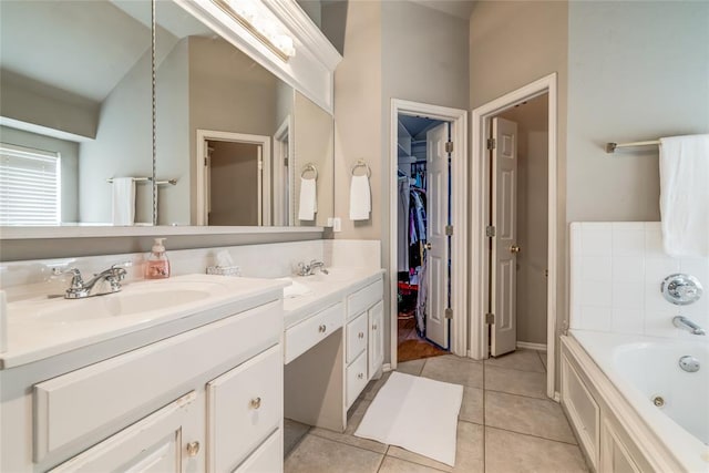 bathroom featuring a bathing tub, tile patterned flooring, and vanity