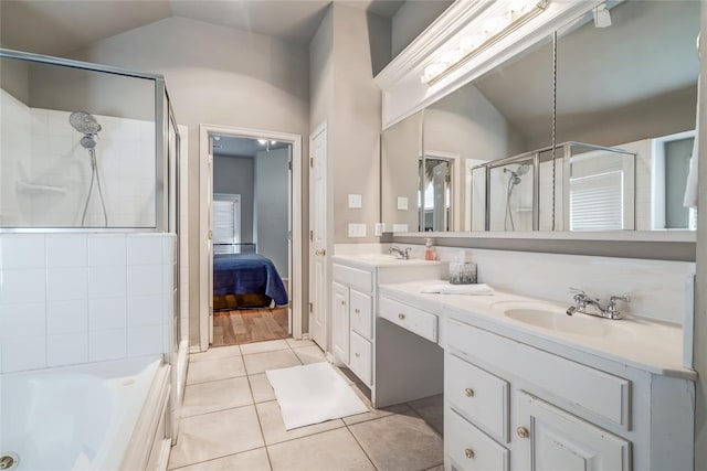 bathroom with tile patterned floors, plus walk in shower, vanity, and lofted ceiling