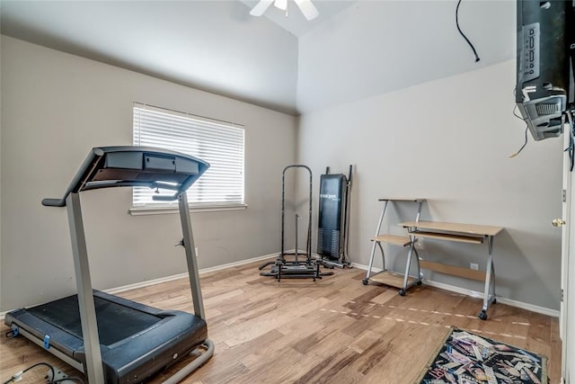 workout area featuring hardwood / wood-style flooring, ceiling fan, and vaulted ceiling