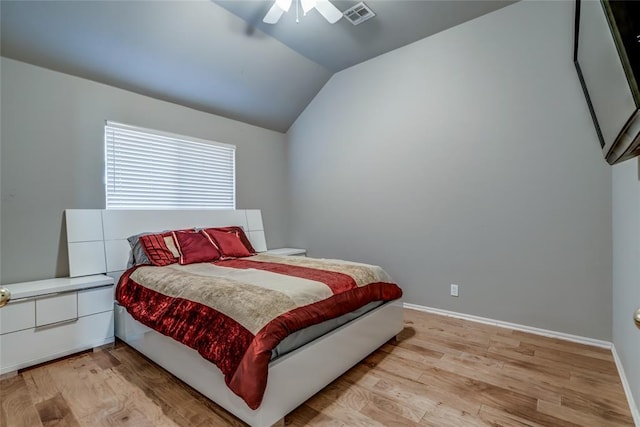 bedroom featuring ceiling fan, light hardwood / wood-style flooring, and vaulted ceiling