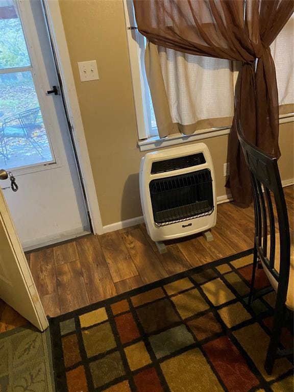 details with heating unit and wood-type flooring