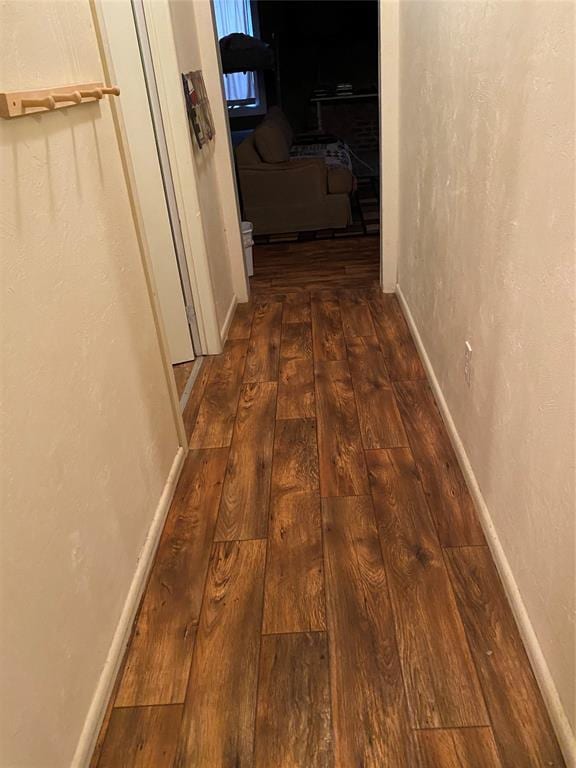 corridor featuring dark hardwood / wood-style floors