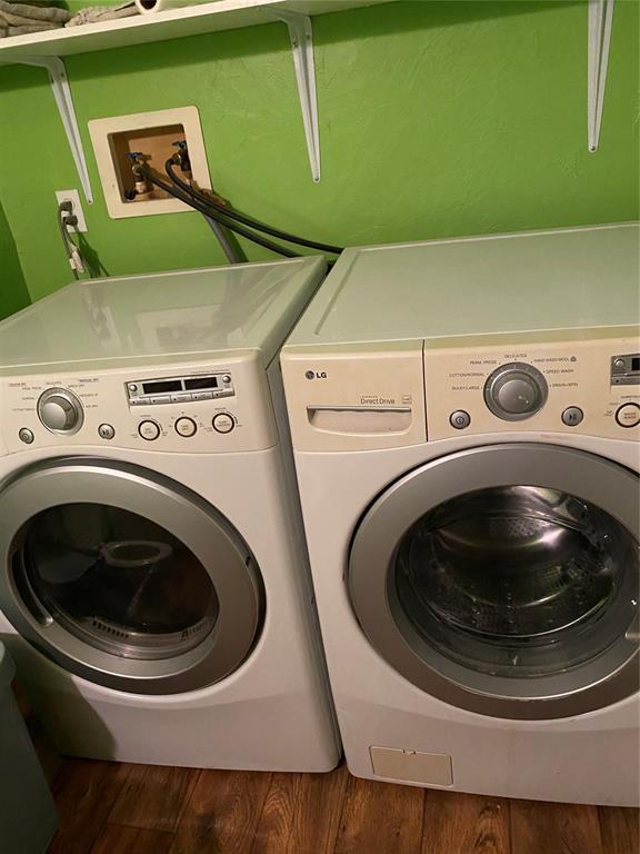 washroom featuring washing machine and dryer and hardwood / wood-style flooring