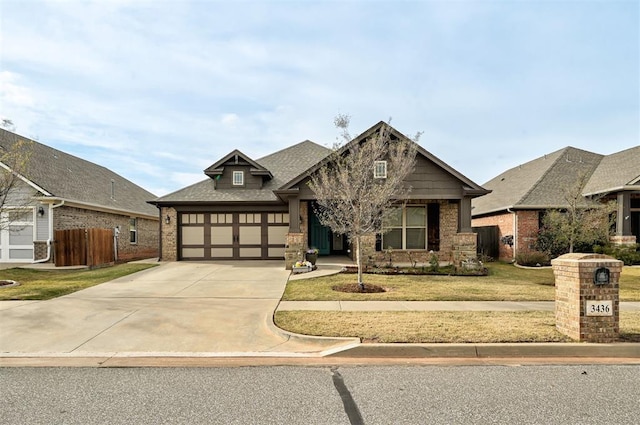 view of front of home featuring a garage and a front lawn