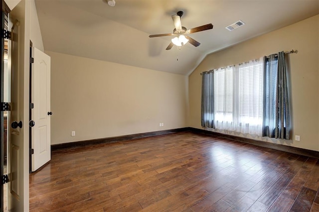 unfurnished room featuring ceiling fan, dark hardwood / wood-style flooring, and vaulted ceiling