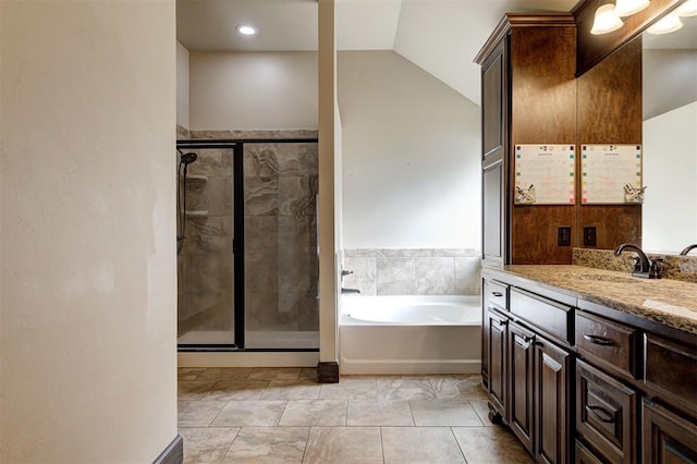 bathroom with plus walk in shower, vanity, lofted ceiling, and tile patterned flooring