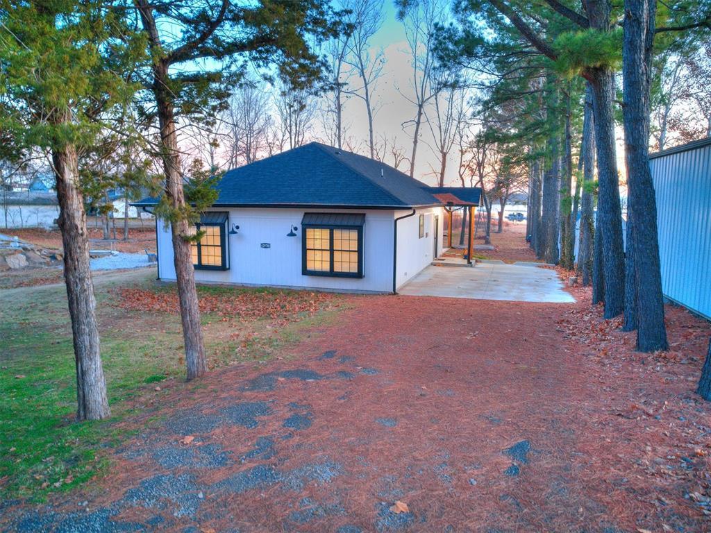 back house at dusk featuring a patio