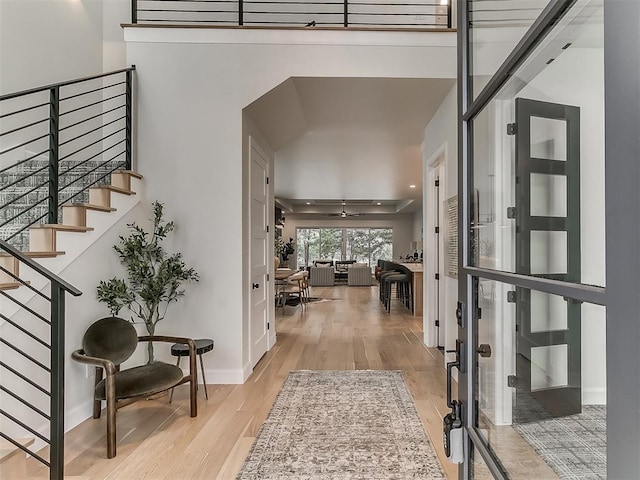 foyer entrance featuring ceiling fan and light hardwood / wood-style floors