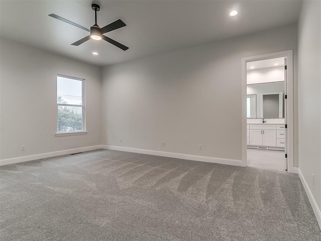 carpeted empty room featuring ceiling fan