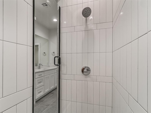 bathroom featuring vanity and tiled shower