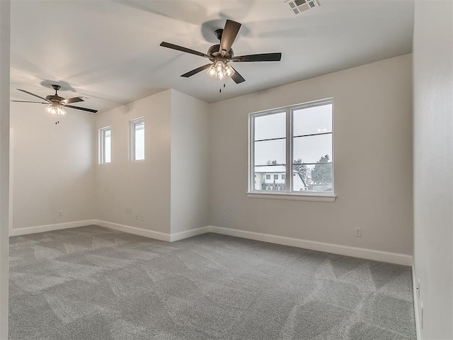 spare room featuring ceiling fan and light colored carpet