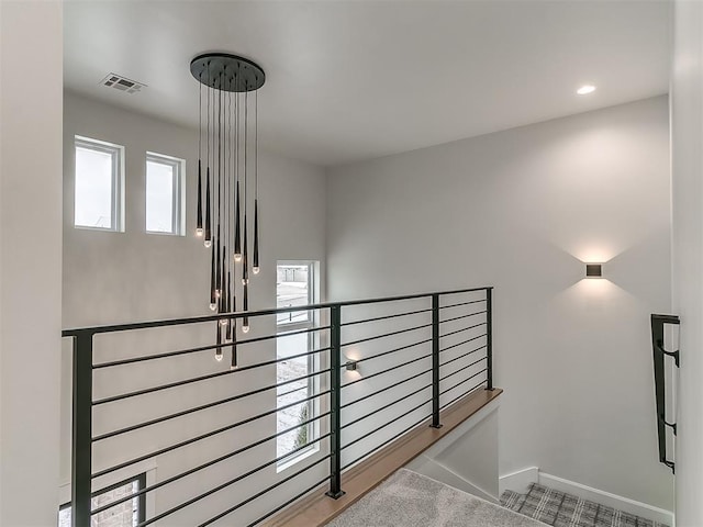 stairs featuring carpet floors and a wealth of natural light