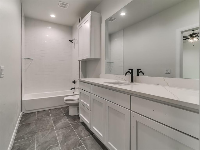 full bathroom featuring vanity, ceiling fan, toilet, and shower / tub combination