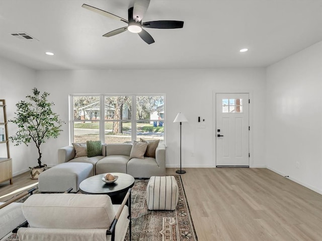 living room featuring ceiling fan and light wood-type flooring