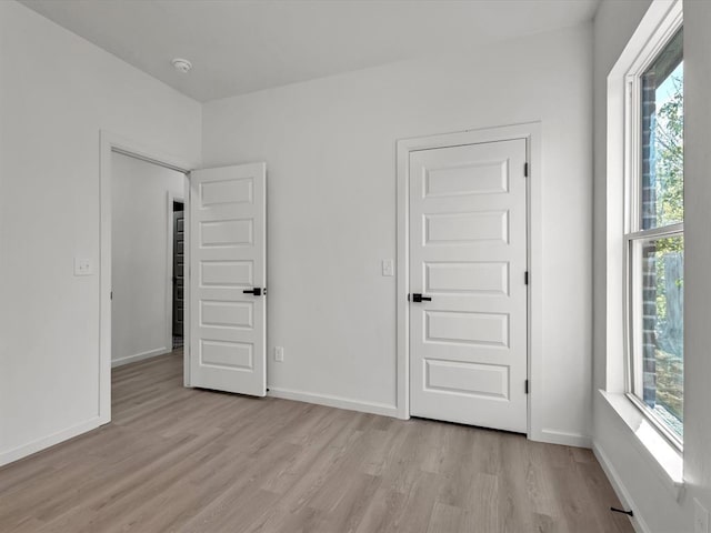 unfurnished room with light hardwood / wood-style flooring