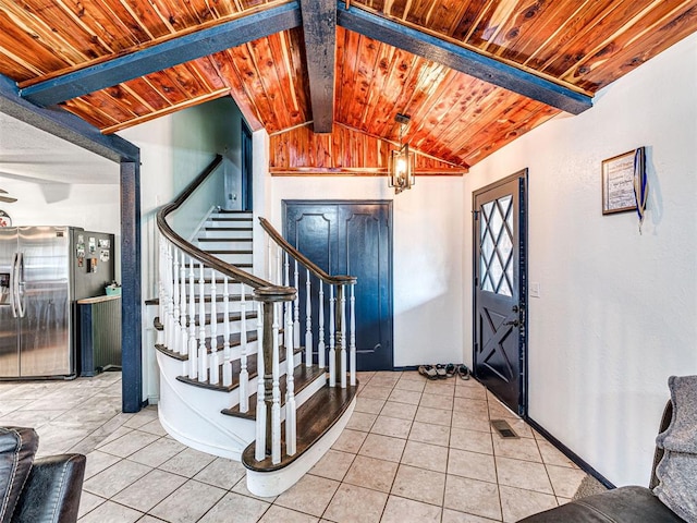 tiled foyer featuring a chandelier, lofted ceiling with beams, and wood ceiling