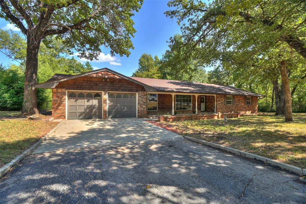 single story home with a front yard and a garage