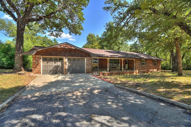 single story home with a front yard and a garage