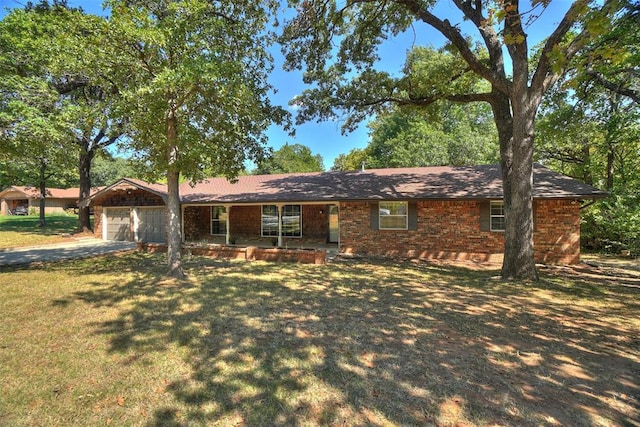 ranch-style house featuring a garage and a front lawn