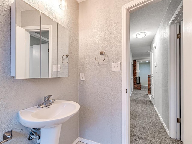 bathroom with a textured ceiling and sink