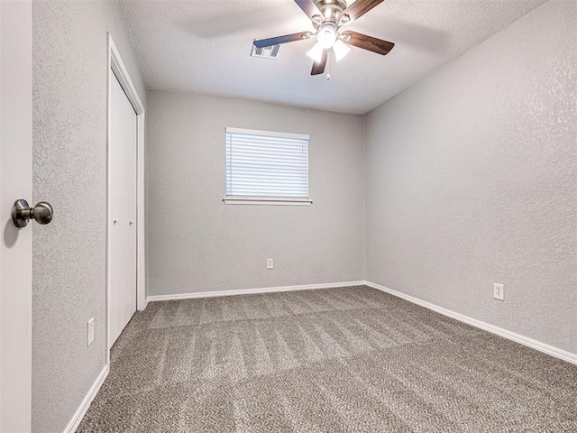 unfurnished bedroom with carpet, ceiling fan, and a textured ceiling