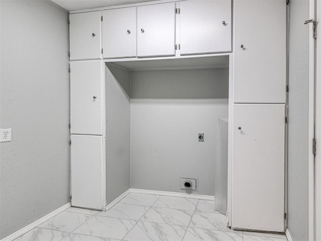 washroom with hookup for an electric dryer and cabinets