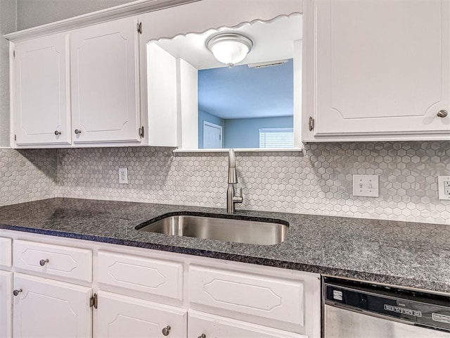 kitchen with white cabinets, dishwasher, sink, and tasteful backsplash