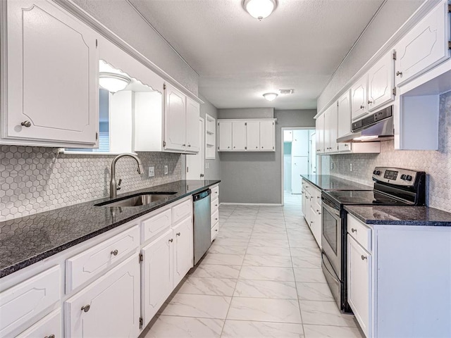 kitchen with white cabinetry, sink, appliances with stainless steel finishes, and dark stone counters