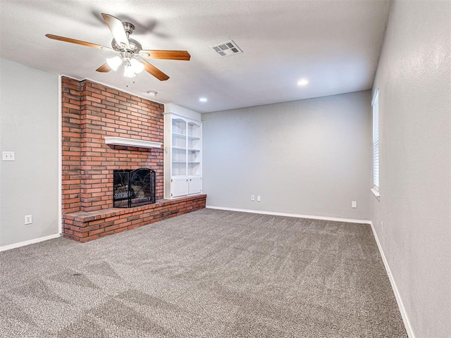 unfurnished living room with carpet, a textured ceiling, a brick fireplace, and ceiling fan