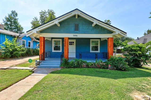 bungalow featuring a porch and a front yard