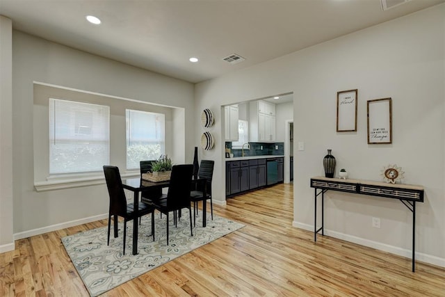 dining room featuring sink and light hardwood / wood-style flooring