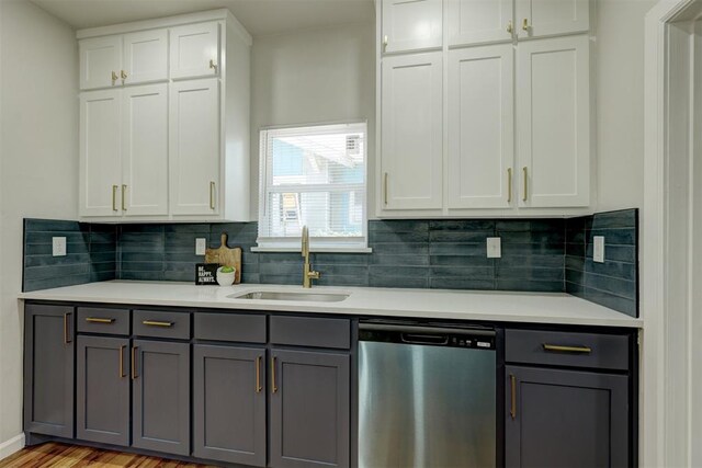 kitchen featuring light wood-type flooring, sink, dishwasher, gray cabinets, and white cabinetry