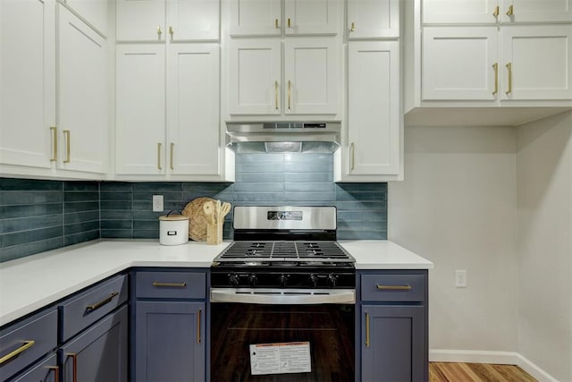 kitchen with backsplash, white cabinetry, extractor fan, and stainless steel range with gas stovetop