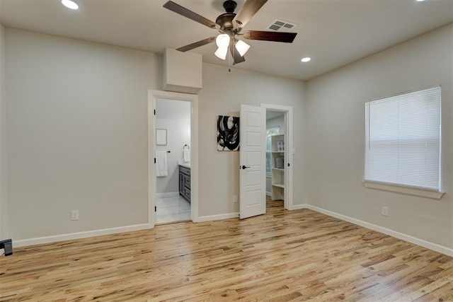 unfurnished bedroom featuring ensuite bathroom, ceiling fan, and light hardwood / wood-style floors