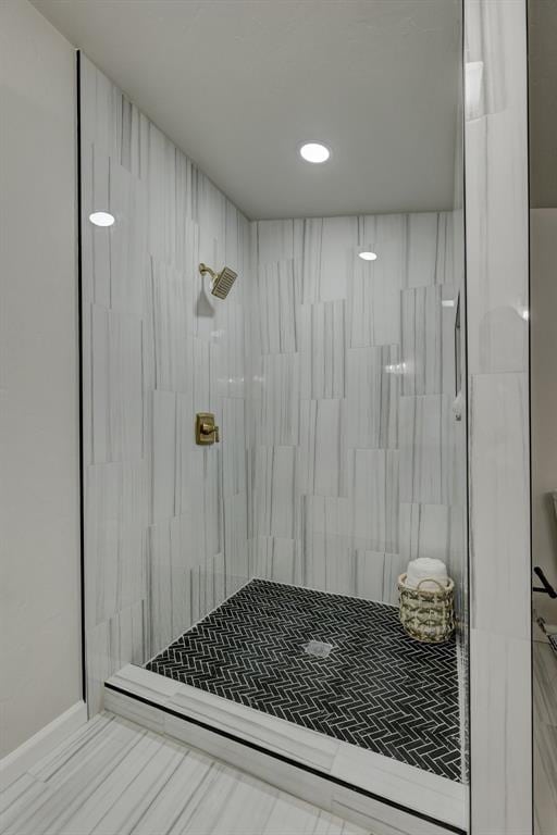 bathroom with tiled shower