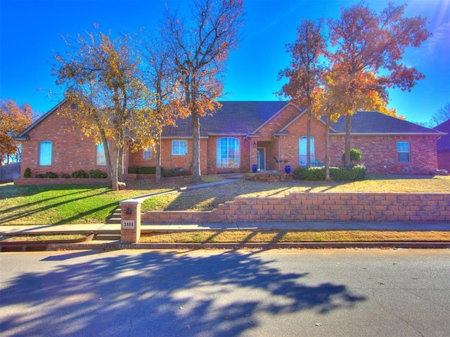 single story home featuring a front yard