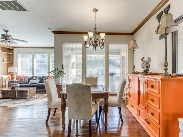 dining space featuring ceiling fan with notable chandelier, dark hardwood / wood-style floors, and ornamental molding