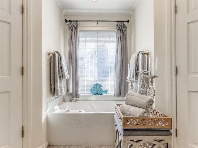 bathroom featuring a tub to relax in and crown molding