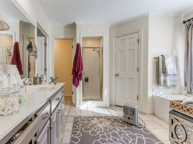 bathroom featuring tile patterned floors, vanity, separate shower and tub, and ornamental molding