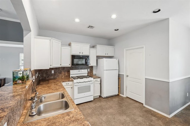 kitchen with sink, white cabinets, white appliances, and decorative backsplash