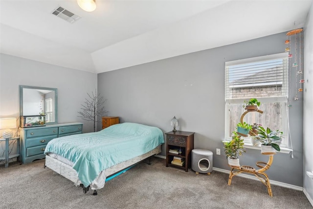 carpeted bedroom with lofted ceiling