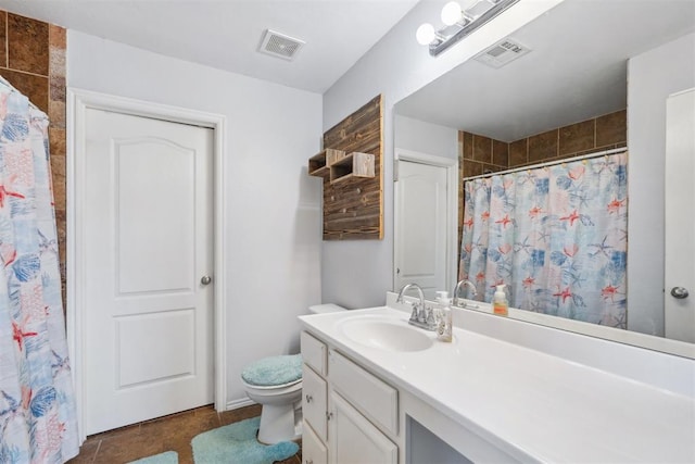 bathroom with tile patterned flooring, vanity, and toilet