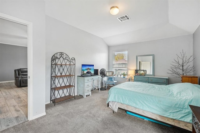 carpeted bedroom featuring vaulted ceiling