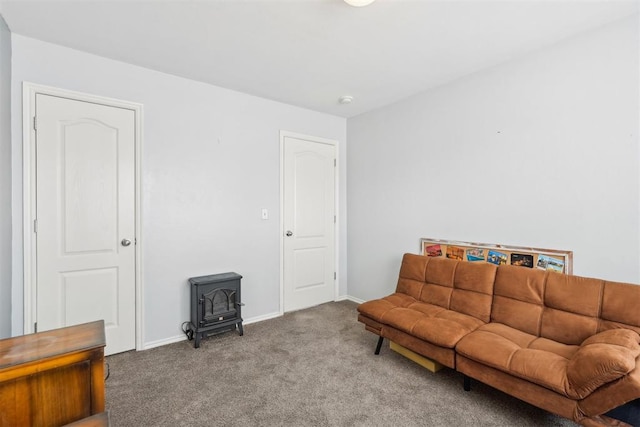 living room with carpet floors and a wood stove